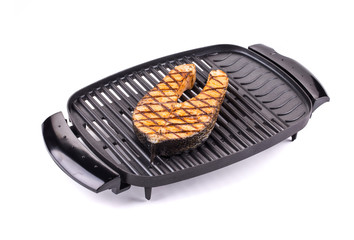 Fried salmon steak on grill.