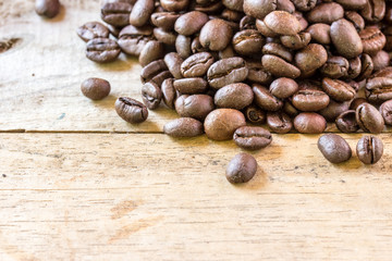 Coffee beans closeup on wooden floors.