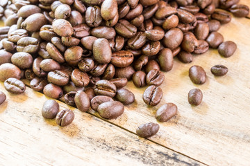 Coffee beans closeup on wooden floors.