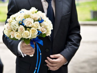 groom and wedding bouquet