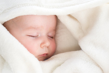 Baby sleeping covered with soft blanket