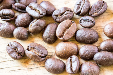 Coffee beans closeup on wooden floors.
