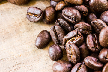 Coffee beans closeup on wooden floors.