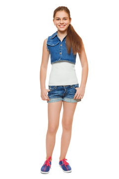 Stylish girl in a jeans vest and shorts. Street style teenager