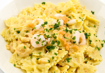 italian pasta called butterflies with shrimp salmon and basil