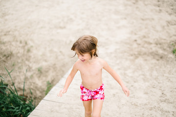 Little girl at the beach on hot summer day