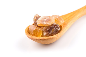 brown caramelized sugar in a wooden spoon