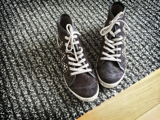 Fashionable shoes on gray striped carpet