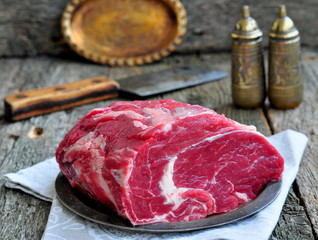 Juicy raw beef steak on wooden table