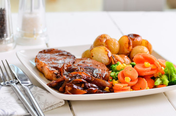 Pork chop Sunday lunch with onion gravy.