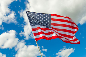 Obraz premium USA flag and cumulus clouds behind it