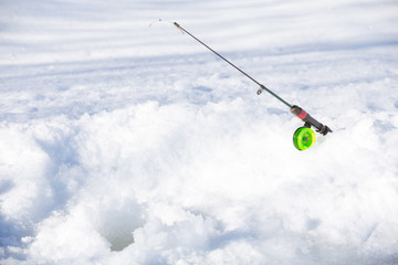 small rod with green coil on snow