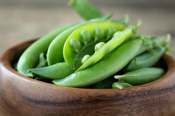 green peas in wooden bowl