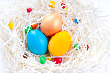 Fototapeta na wymiar Colorful Easter eggs in nest on white background
