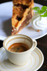 Fresh coffee on wooden table. Espresso coffee short on table.