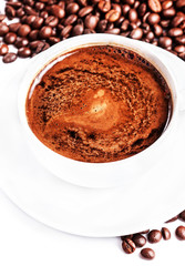 Coffee cup and saucer with roasted coffee beans isolated on a wh
