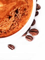 Coffee cup and saucer with roasted coffee beans isolated on a wh