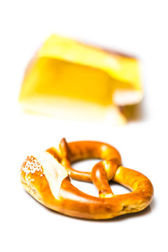 Fresh German pretzel  out of its paper bag on white