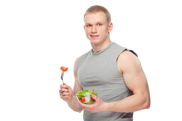 Shaped and healthy body man holding a fresh salad bowl,shaped