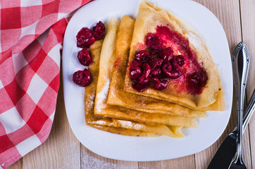 pancakes with jam and berries on a plate