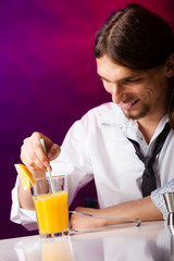 Young man bartender preparing alcohol cocktail drink