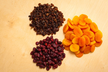 Dried fruits raisins apricots cranberries on table