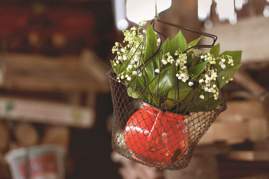 bouquet of lily of the valley in the old red jug - vintage