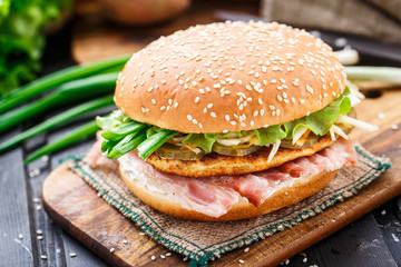 Burger with potato pancake and bacon