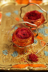 saffron spice in antique vintage glass bowl, closeup