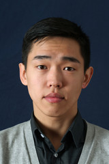 Young Asian man looking at camera
