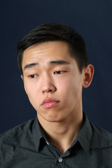 Fototapeta premium Romantic young Asian man looking down