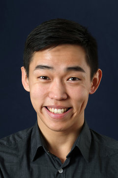 Young Asian man smiling and looking at camera