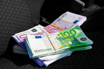 macro photo of a pack of money EUR on a car seat