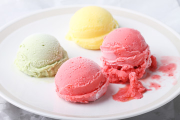 ice cream scoops on white round plate