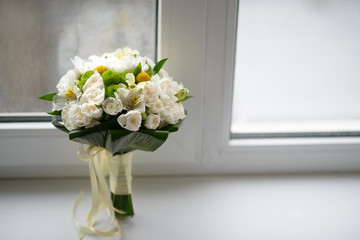 Nice and pretty bridge bouquet on  the window
