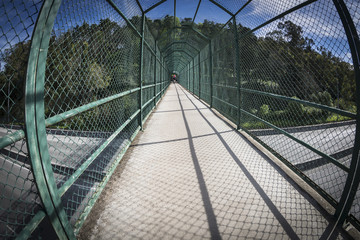 interior of a walkway bridge with protective metal mesh