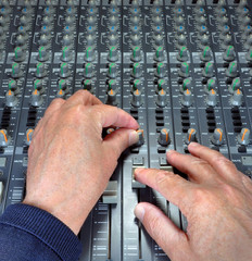 Hands Operating Music Mixing Desk