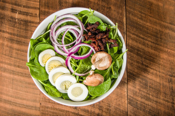 Bowl of egg and spinach salad