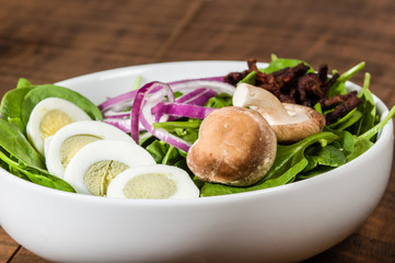 Bowl of egg and spinach salad