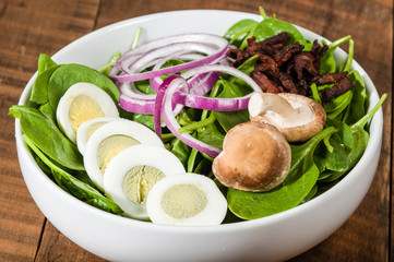 Bowl of egg and spinach salad