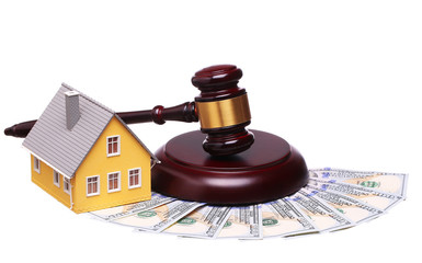 Concept of house sale with gavel and money isolated on white