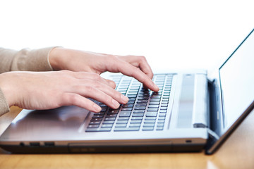 Female hand on laptop keyboard