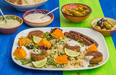 Quinoa with roasted pumpkin, falafel and sausages