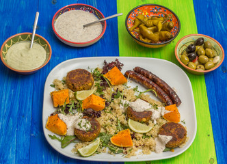 Quinoa with roasted pumpkin, falafel and sausages
