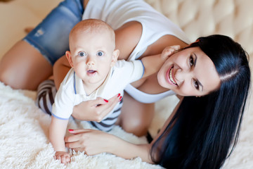 Mother are lovely playing  with baby in bed