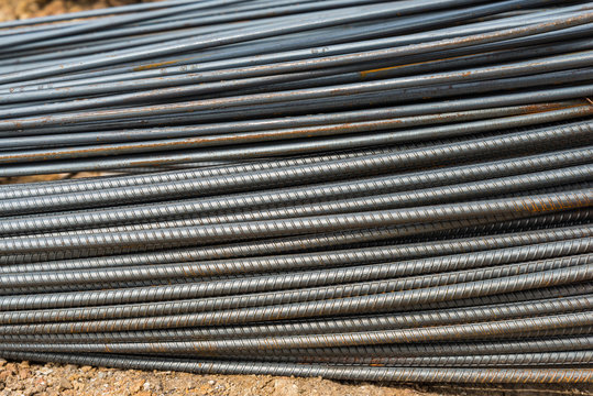 Steel rods or bars used to reinforce concrete in construction