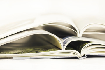 a pile of magazines close up on white background
