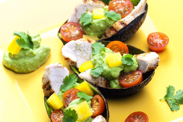 avocado filled with chicken salad and avocado dip