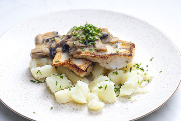 pikeperch on butter with mushroom sauce and spring potatoes