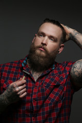 Obraz premium Male with tattoo on arms in studio
